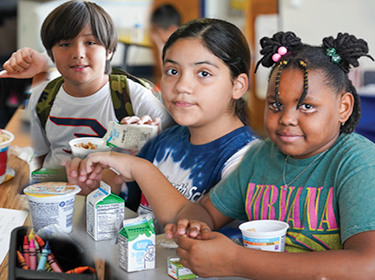  Phoenix Elementary School District #1 students enjoying Breakfast in the Classroom