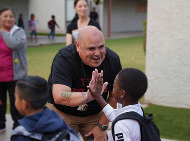  Principal Fuentes hi-fiving students on First Day of School
