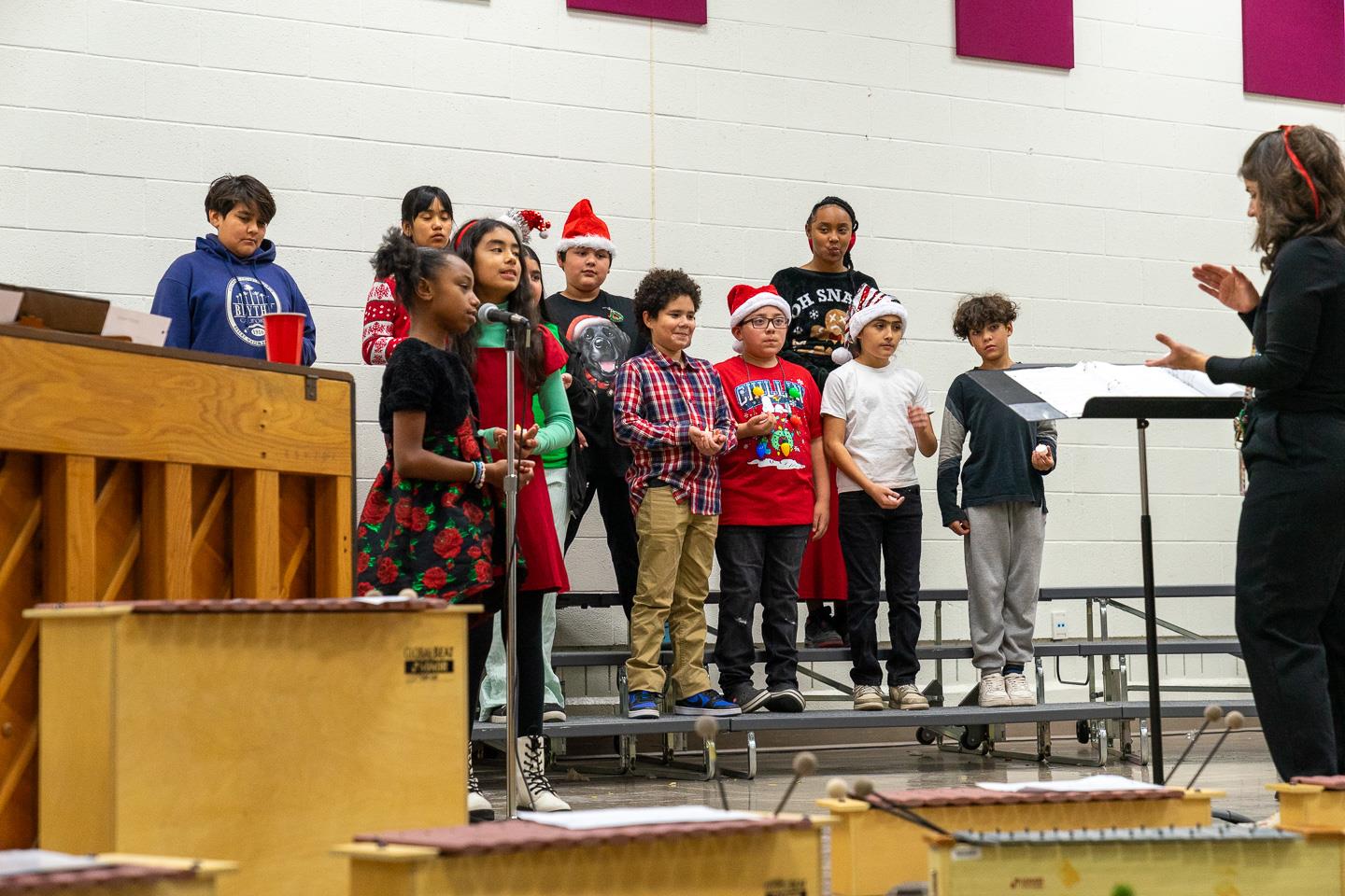 A group of upper elementary students took the stage, singing their hearts out alongside their teacher on piano—a moment of pure talent and joy!